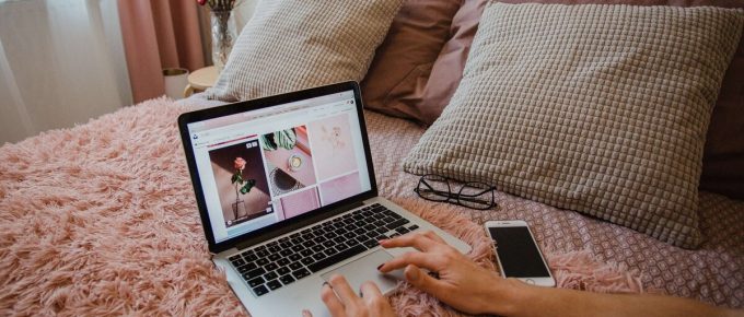 laptop on bed - savvy content for paid social ads